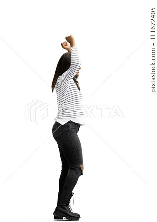 A woman, on a white background, in full height, raised her hands up 111672405