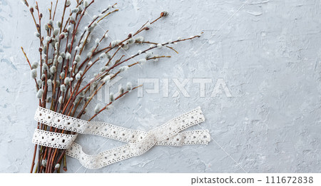 banner willow branches and cotton ribbon on grey concrete background, 111672838