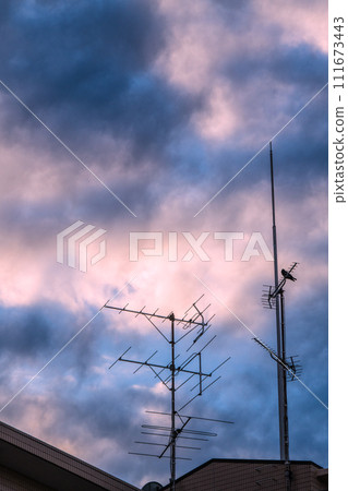 Tokyo cityscape in Japan Antenna and clouds installed on the roof of an apartment building... What will be the TV in the future... 111673443