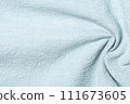 Background of light blue fabric with folds, textured background 111673605