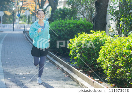 Young woman running 111673958
