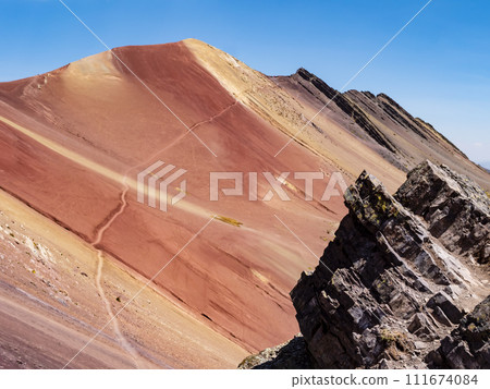 Colored rocks of the Red Valley (valle rojo) with adventurous path leading to the top of the mountain, Cusco region, Peru 111674084