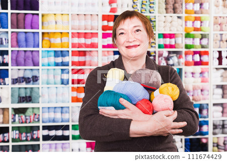 Mature female with colorful yarn for their hobby Mature female with colorful yarn for their hobby 111674429