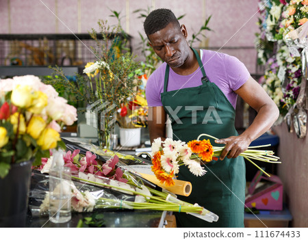 Florist making bouquet with gerberas Florist making bouquet with gerberas 111674433