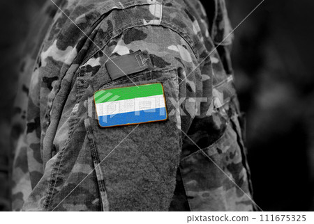 Flag of Sierra Leone on soldiers arm. Sierra Leone flag on military uniform. Army, troops, Africa (collage). 111675325