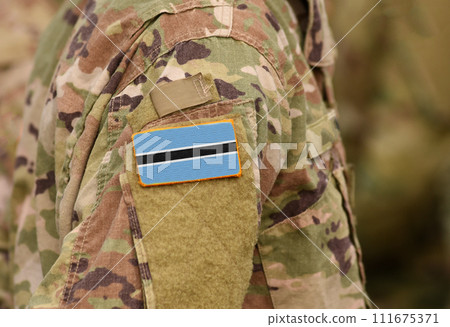 Botswana flag on soldiers arm. Republic of Botswana troops (collage) Botswana flag on soldiers arm. Republic of Botswana troops (collage) 111675371