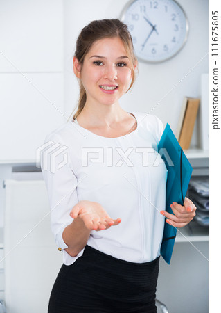 Woman with clipboard welcoming to office 111675805