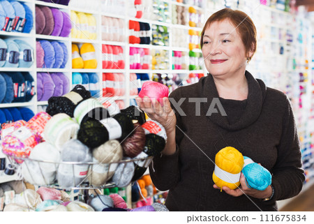 Mature customer in yarn shop 111675834