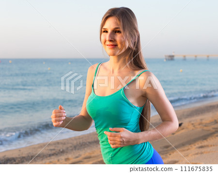 Female in blue T-shirt is jogging Female in blue T-shirt is jogging 111675835