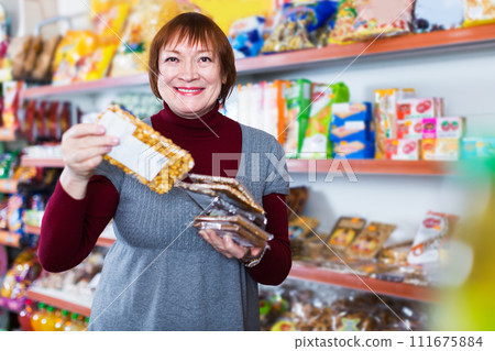 female choosing bars in store female choosing bars in store 111675884