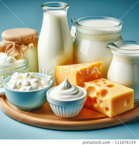 Different milk products: cheese, cream, milk, yoghurt. On a blue background. 111676154