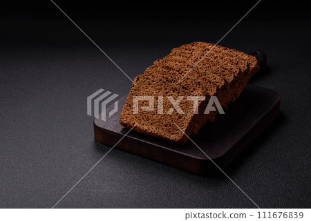 Delicious brown bread with seeds and grains cut into slices 111676839