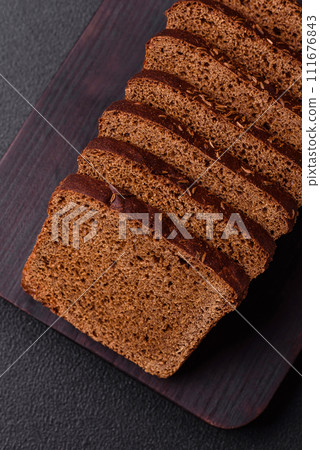 Delicious brown bread with seeds and grains cut into slices 111676843