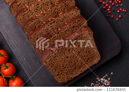 Delicious brown bread with seeds and grains cut into slices 111676845