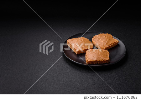 Delicious hearty sandwich with toast bread and peanut butter 111676862