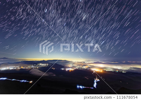 The starry sky and the city lights of Gotemba, Shonan, and Kanto plains seen from Mt. Fuji and Mt. Hoei The starry sky and the city lights of Gotemba, Shonan, and Kanto plains seen from Mt. Fuji and Mt. Hoei 111678054