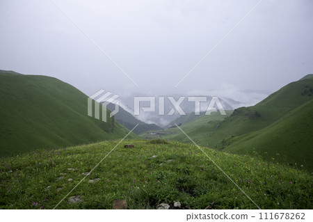 Landscape high mountains in dense fog tops of mountains in clouds North Caucasus Elbrus 111678262