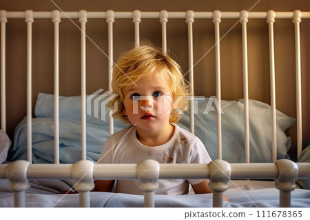 Portrait of cute little boy with blond hair sitting on bed at home Portrait of cute little boy with blond hair sitting on bed at home 111678365