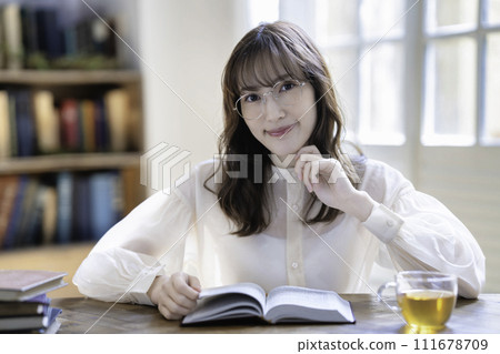 Woman reading a book leisurely on holiday Woman reading a book leisurely on holiday 111678709