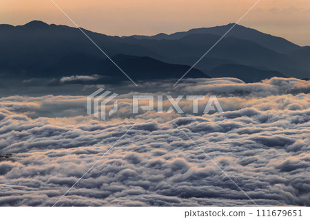 Tanzawa, Mt. Tonodake, Mt. Daisen and a sea of clouds at dawn seen from Mt. Fuji and Mt. Hoei 111679651