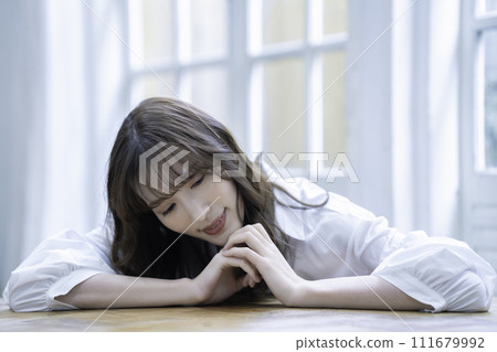 A woman with a feminine atmosphere relaxing in the room A woman with a feminine atmosphere relaxing in the room 111679992