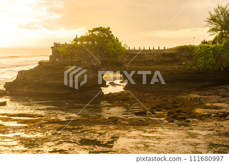Pura Batu Bolong an iconic Hinduism sea temple nearly Tanah Lot temple in Bali island of Indonesia at evening. 111680997