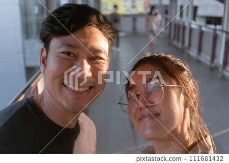 Couple of man and woman is taking selfie together. 111681432