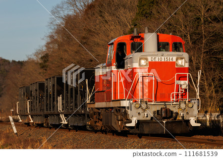 DE10 diesel locomotive freight train running in the setting sun 111681539