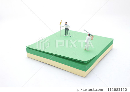 Golfer Figurine on Golf Ball on the memo pad Golfer Figurine on Golf Ball on the memo pad 111683130