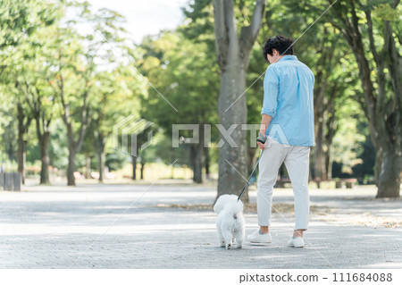 Rear view, exercise, and dog therapy of a middle-aged and elderly dog lover walking his dog 111684088