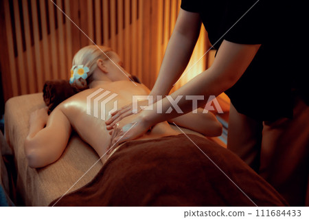 Caucasian woman customer enjoying relaxing anti-stress massage. Quiescent 111684433