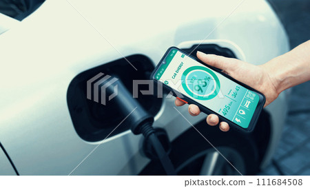Smartphone display battery status interface by smart EV app. Peruse Smartphone display battery status interface by smart EV app. Peruse 111684508
