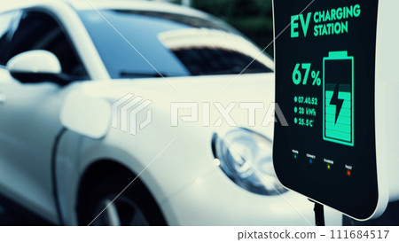 Electric car connected to charging station at public car park Peruse 111684517
