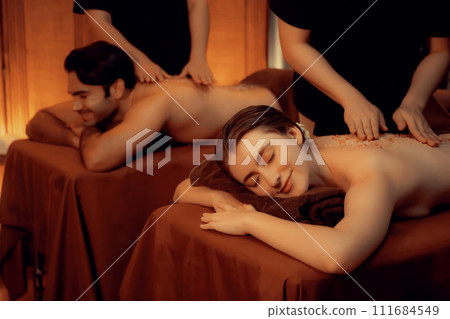 Couple customer having exfoliation treatment in luxury spa. Quiescent Couple customer having exfoliation treatment in luxury spa. Quiescent 111684549