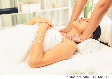 Caucasian woman customer enjoying relaxing anti-stress massage. Quiescent Caucasian woman customer enjoying relaxing anti-stress massage. Quiescent 111684616