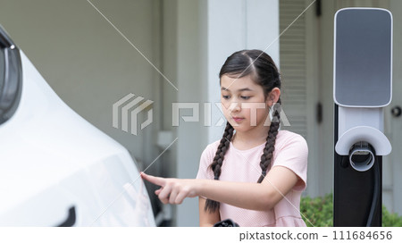 Electric vehicle and modern family at home concept. Synchronos Electric vehicle and modern family at home concept. Synchronos 111684656