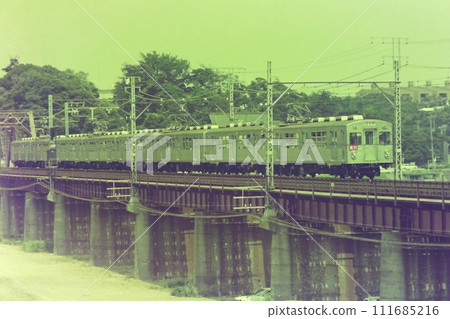 7000 series express train, 7028 and 8 other cars running on the old Tamagawa bridge on the Toyoko Line, July 30, 1976 111685216