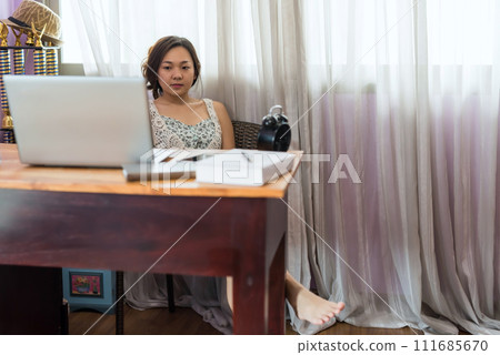 Asian woman watch streaming movie from laptop on table 111685670