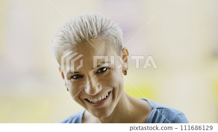 Modern and stylish woman laughing at camera Modern and stylish woman laughing at camera 111686129