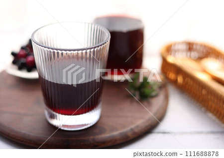 Grape juice poured into a stylish glass 111688878