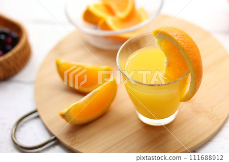 Fresh oranges and orange juice in a glass Fresh oranges and orange juice in a glass 111688912