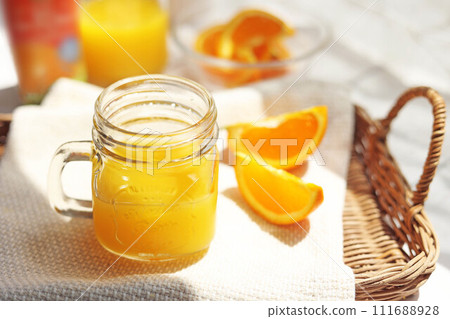 orange juice poured into a mason jar orange juice poured into a mason jar 111688928