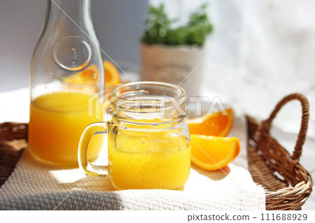 orange juice poured into a mason jar orange juice poured into a mason jar 111688929