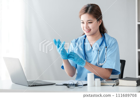 Young hispanic woman wearing doctor uniform wearing gloves at clinic 111689708