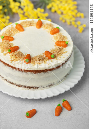 Homemade carrot cake made with walnuts, iced with cream cheese. Sweet dessert. Homemade carrot cake made with walnuts, iced with cream cheese. Sweet dessert. 111691168