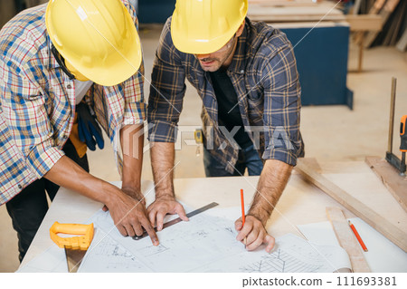 Two carpenter man wear meeting planning job together at carpentry workshop, craftsmen talking on construction plan blueprint, Happy Carpenter's Day 111693381