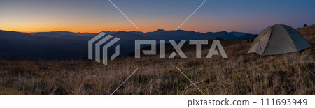 Panorama of landscape with a tourist tent. Mountain peaks Mountain range. Tourism and hiking. Panorama of sunset in the mountains. Panorama of landscape with a tourist tent. Mountain peaks Mountain range. Tourism and hiking. Panorama of sunset in the mountains. 111693949