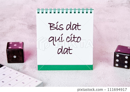 Bis dat qui cito dat It is translated from Latin as The one who gives twice is the one who gives quickly It is written on a white sheet of a notebook Bis dat qui cito dat It is translated from Latin as The one who gives twice is the one who gives quickly It is written on a white sheet of a notebook 111694917