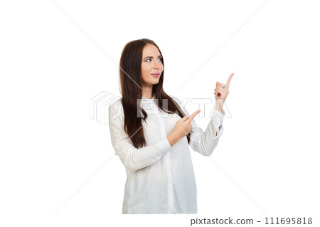 Young, beautiful girl on a white background points his fingers at the place for promo, offers or advertising. 111695818
