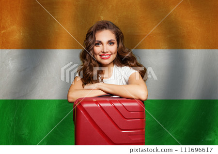 Welcome to India. Young happy woman with red suitcase on Indian flag background. Welcome to India. Young happy woman with red suitcase on Indian flag background. 111696617